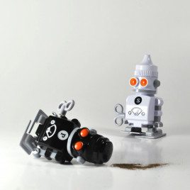Salt and pepper robot shakers on table